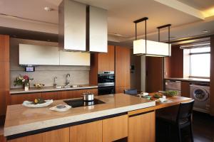 a kitchen with wooden cabinets and a counter top at The Classic 500 Pentaz Executive Residence in Seoul