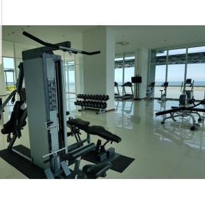 un gimnasio con cintas de correr y máquinas en un edificio en 2 Bed Room Amazing Sea View Condo 80sqm Fast Internet, en Yakarta