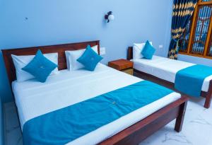 A bed or beds in a room at MRD Beach Hotel