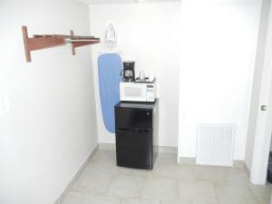 a kitchen with a microwave on a black refrigerator at The Surrey Inn in Caldwell