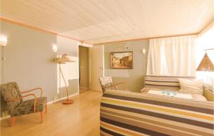 TämtaにあるStunning Home In Fristad With Wifiのベッド1台、椅子2脚、窓が備わる客室です。