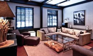 a living room with a couch and a table at Hakuba Mountain Apartment in Hakuba