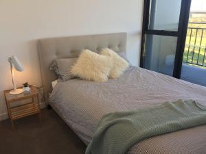a bed with a furry pillow on top of it at YARRAVILLE 2 bed 2 bath in Yarraville