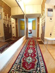 a hallway with a red rug on the floor at Малко oазисче in Sofia