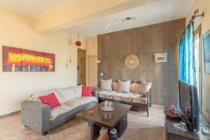 a living room with a couch and a table at Cosy apartment in Stoupa in Stoupa