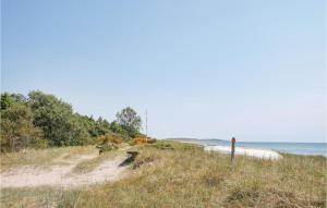 a sandy beach with the ocean in the background at Awesome Home In Nybrostrand With Wifi in Kabusa