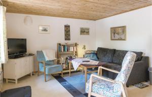 a living room with a couch and a table at Awesome Home In Nybrostrand With Wifi in Kabusa