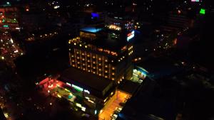an overhead view of a tall building at night at Hotel Blossoms in Tiruchchirāppalli