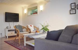 a living room with a couch and a table at Awesome Home In Lttorp With Kitchen in Löttorp