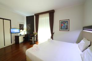 Postel nebo postele na pokoji v ubytování Grande Albergo Maugeri