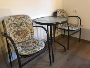 two chairs and a table and a table and chairs at Country house Plitvice in Plitvica Selo