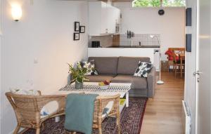 a living room with a couch and a table at Awesome Home In Lttorp With Kitchen in Löttorp