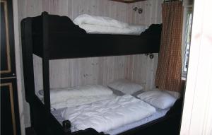three bunk beds in a room with white pillows at Amazing Home In Hemsedal With 7 Bedrooms, Sauna And Wifi in Hemsedal