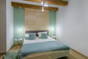 a bedroom with a bed and a lamp at All Season Studios in Braşov