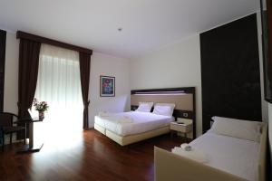 Postel nebo postele na pokoji v ubytování Grande Albergo Maugeri