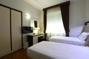 Postel nebo postele na pokoji v ubytování Grande Albergo Maugeri