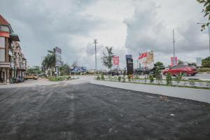 an empty parking lot in a town with cars at RedDoorz Plus near Ferry Terminal Batam Center in Batam Center