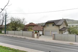 a house on the side of a street with a fence at Hava 2 in Sarajevo