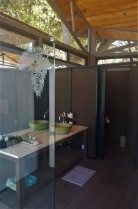 a bathroom with a sink and a table with a mirror at Greenfire Game Lodge in Balule Game Reserve +37 photos