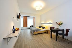 a living room with a bed and a table at Ford Apartment Bremen City Center in Bremen