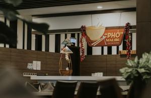 a restaurant with a cup of coffee on the wall at The Malibu Hotel in Vung Tau