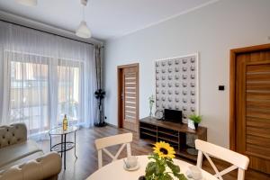 a living room with a couch and a table at Angels Home Toruń in Toruń