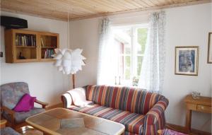 a living room with a couch and a window at Stunning Home In Nordmarkshyttan in Nordmarkshyttan