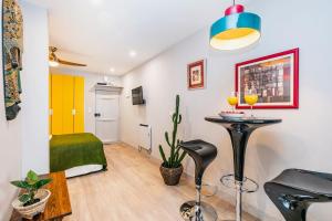 a living room with a table and a bed at Brand new and cozy studio: Bairro Alto/ Chiado in Lisbon