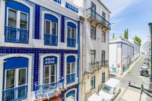 a blue and white building on a city street at Brand new and cozy studio: Bairro Alto/ Chiado in Lisbon