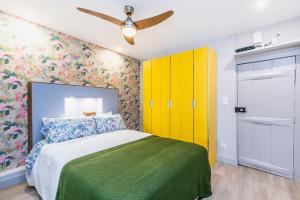 a bedroom with a bed and a yellow closet at Brand new and cozy studio: Bairro Alto/ Chiado in Lisbon