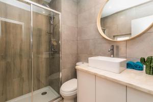 a bathroom with a toilet and a sink and a mirror at Brand new and cozy studio: Bairro Alto/ Chiado in Lisbon