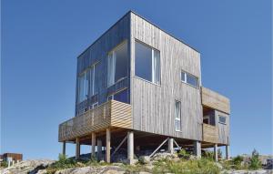 a house on top of a cliff at Four-Bedroom Holiday Home In Sondeled in Søndeled