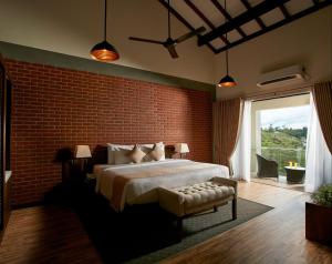 a bedroom with a large bed and a brick wall at The Argyle Luxury Boutique in Hatton
