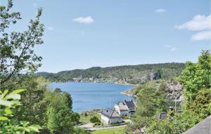 a view of a lake with houses and trees at 1 Bedroom Awesome Home In Tvedestrand in Tvedestrand