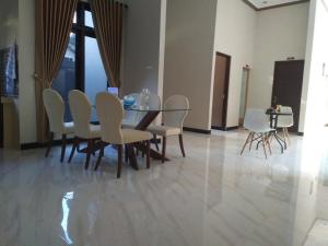 a dining room with a table and chairs at Homestay Purbalingga Tengah Kota by Simply Homy in Purbolinggo