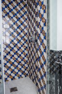 a shower with blue and white tiles on the wall at Hotel Marina Riviera in Amalfi