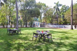 a group of tables and chairs in a park at Hotel Mangal Residency Lonavala - Best Hotel in Lonavala in Lonavala