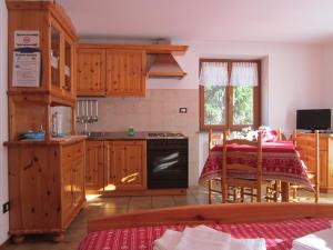 a kitchen with a table and a stove top oven at Residence Delapierre in Gressoney-Saint-Jean