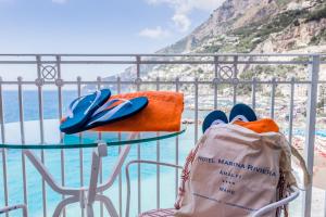 a table and chairs with a view of the ocean at Hotel Marina Riviera in Amalfi