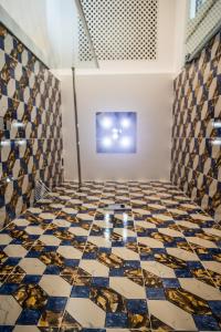 a room with a tiled floor with a painting at Hotel Marina Riviera in Amalfi