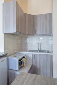a kitchen with a white stove and a sink at Cosy studio in Stoupa in Stoupa