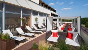 a row of lounge chairs on a deck in front of a building at OREA Resort Santon Brno in Brno