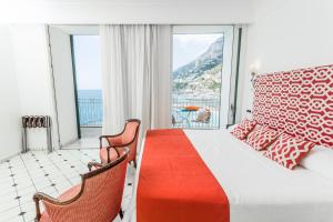 a bedroom with a bed and a view of the ocean at Hotel Marina Riviera in Amalfi