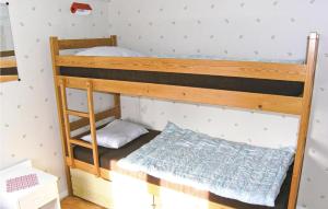 a bunk bed room with two bunk beds in it at Nice Home In Hjltevad With 1 Bedrooms in Hjältevad