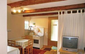 a kitchen with a table and a tv in a room at Lovely Home In Blankenburg With Wifi in Blankenburg +8 photos