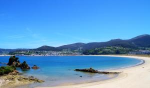 a view of a beach with mountains in the background at Duerming Family Viveiro 4 Rooms in Viveiro