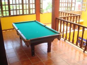 a pool table sitting on a floor in a room at Posada Aguila Real in Palenque
