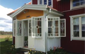 a screened in porch on the side of a house at Cozy Home In Skillingaryd With Wifi in Nydala