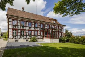 a large house with red and white at Historische Residenz Lindeneck in Güttingen