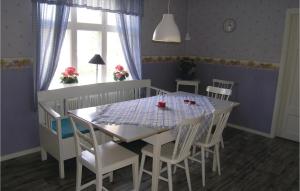 a dining room with a table and chairs and a window at Two-Bedroom Holiday Home In Langaryd in Långaryd